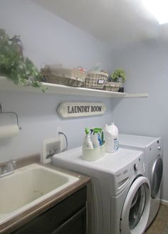 a washer and dryer in a laundry room with shelves above the washer