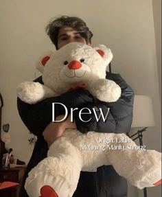 a man holding a white teddy bear in his arms with the words drew on it