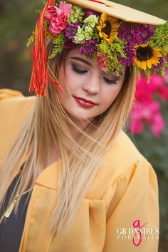 a woman with long blonde hair wearing a yellow hat and flowers on it's head