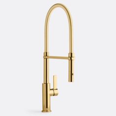 a brass faucet with two handles and nozzles on the side, in front of a white background