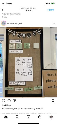 a bulletin board with words on it and pictures taped to the wall behind it,