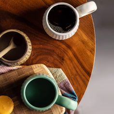 two cups of coffee on a wooden table