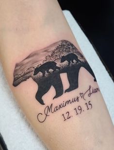 a couple of bears on the arm with their names and date tattooed to it's side