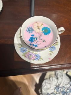 a bowl of food sitting on top of a table next to a plate with flowers