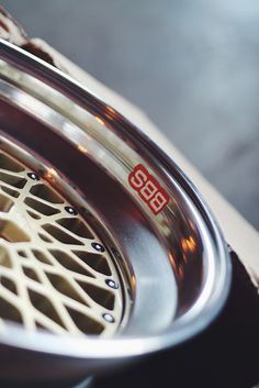 a close up view of the spokes on a car wheel with red and white decals