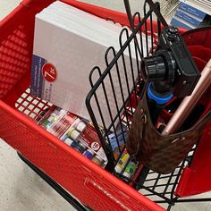 a red shopping cart filled with lots of items