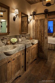 a rustic bathroom with double sinks and wooden cabinets