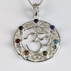 "These pendants are handcrafted from beautiful .925 sterling silver. Featuring a shiny lustrous Om symbol design with seven, high-grade, polished chakra crystals including: Root: Garnet Sacrum: Carnelian Solar Plexus: Citrine Heart: Peridot Throat: Blue topaz Third Eye: Lapis Crown: Amethyst Add a high-quality sterling silver adjustable chain. Pendant length: 1.6\" ♥️Fast & Free USA Shipping w/ purchase of $35 or more♥️ We also offer low International shipping, calculated based on your location. Festival Gemstone Jewelry Gift, Spiritual Silver Birthstone Jewelry, Spiritual Silver Jewelry With Birthstone, Spiritual Gemstone Jewelry For Festivals, Silver Spiritual Birthstone Necklace, Spiritual Silver Birthstone Necklace, Silver Spiritual Necklace With Birthstone, Symbolic Sterling Silver Necklaces For Festivals, Silver Amulet Necklace With Birthstone