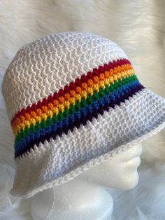 a white crocheted hat with multicolored stripes