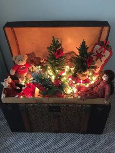 a trunk filled with christmas trees and teddy bears