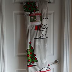 a towel hanging on the front door with snoopy christmas tree and dog in it