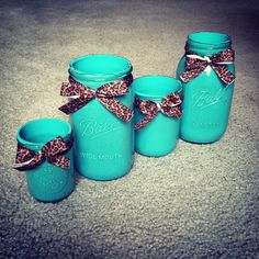 blue mason jars with leopard print bows are sitting on the floor next to each other