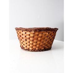 a woven basket sitting on top of a white table