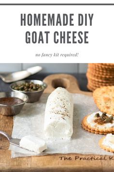 homemade diy goat cheese on a cutting board with crackers and spoons next to it