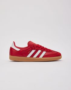 The adidas Samba is a soccer shoe turned international style icon. This low-profile silhouette features a smooth leather upper, 3-stripe overlays, and soft leather mudguards. Leather upper Leather overlays 3-Stripes branding "Samba" lettering Traditional lacing system Padded tongue with Trefoil logo branding Rubber sol Red Sambas, Daisy Clothes, Cinderella Slippers, Stripes Branding, 16 Gifts, Adidas Og, Profile Silhouette, Sweet 16 Gifts, Womens Adidas