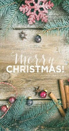 a wooden background with christmas decorations and the words merry christmas