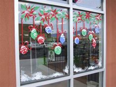 a window decorated with christmas decorations and candy canes