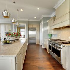 a kitchen with white cabinets and an island