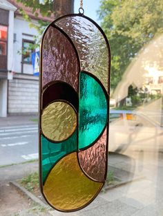 a stained glass window hanging on the side of a building