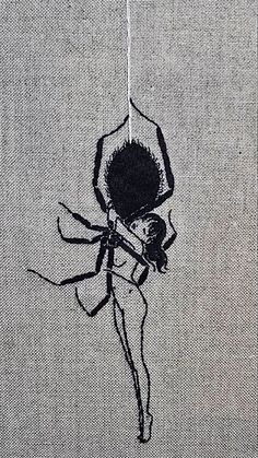 a drawing of a spider hanging from a thread on a piece of cloth with black ink