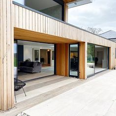 an open living room with sliding glass doors on the outside and wood paneling on the inside