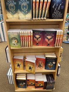 a book shelf filled with lots of books on top of each other in a store