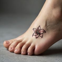 a woman's foot with a flower tattoo on it