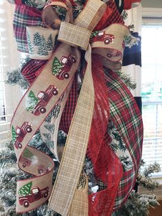 a christmas tree decorated with burlocks and plaid ribbon is in the shape of a truck