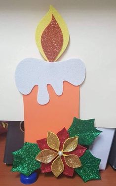 a birthday candle is decorated with glitters and leaves