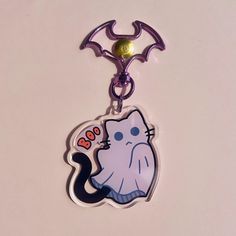 a keychain with a cartoon cat on it's front and back ends