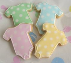 three decorated cookies in the shape of baby ones