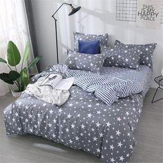 an unmade bed with blue and white stars on it