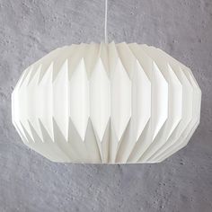 a white paper lantern hanging from a ceiling