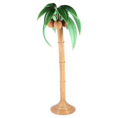 a tall wooden palm tree with green leaves on it's top and brown base