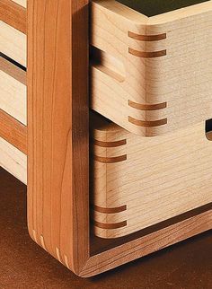 a close up of a wooden drawer with drawers on the bottom and one drawer open