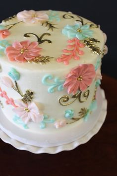 a white cake with pink and blue flowers on it