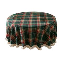 a green and red plaid tablecloth with tassels on the edge is shown