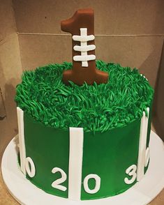 a football themed cake with green grass and white frosting