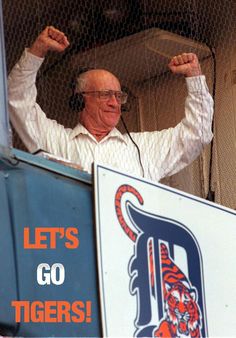 an older man is cheering from the stands at a baseball game with his fist in the air