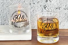 a couple of glasses sitting on top of a wooden table