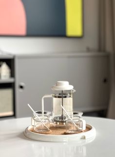 a coffee maker sitting on top of a white table