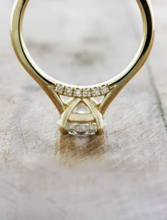 a yellow gold ring with two diamonds on it