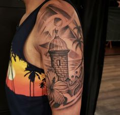 a man with a lighthouse tattoo on his arm