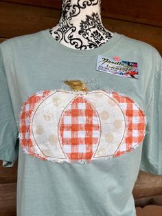 Adorable vintage distressed Pumpkin shirt that is stitched in an open edge vintage style bean stitch, and the fabric is purposely frayed.  This stitch allow the fabric to fray a little more with each wash.    You can choose between a Bella Canvas or Gildan soft style. Custom orders are done as well. Check out our Facebook page too. https://www.facebook.com/Needle-Nut-Embroidery-100913691324151/ Fall Patchwork Short Sleeve T-shirt, Fall Cotton Shirt With Patchwork, Vintage Washed T-shirt For Fall, White Distressed T-shirt For Fall, Distressed Relaxed Fit Shirt For Fall, Short Sleeve Patchwork T-shirt For Fall, Vintage Distressed Tops For Fall, Vintage Washed Shirt For Fall, Vintage Distressed Cotton Shirt