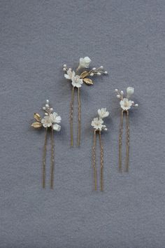 The prettiest feminine set of 4 delicate floral hair pins. They feature hand sculpted flowers, small leaves and sprigs of pearls and high quality life like brass leaves, all hand wired and attached to hair pins. Scatter these pins to adorn a romantic/tousled updo or half up hairstyle, or place them neatly in a row for a more polished look. Designer note: we understand finding the perfect hair piece can be challenging sometimes so we designed this set of hair pins to suit a range of hairstyles and to be used with various combinations - we are showing you 3 different ways to style them in the listing photos but there's no limit to your creativity. They're also the perfect adornment if you plan to have two different hairstyles on your special day.  DETAILS - Designed and handmade in Sydney, A Romantic Wedding Hair Updo, Tousled Updo, Half Up Hairstyle, Floral Wedding Hair, Elegant Floral Wedding, Hair Pins Bridal, Wedding Hairpiece, Small Leaves, Floral Hair Pins