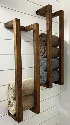 two wooden shelves holding towels and folded towels