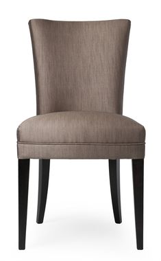 an upholstered chair with dark wood legs