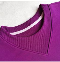 a purple t - shirt with white stripes on it