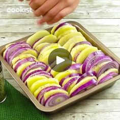 a pan filled with sliced red and yellow onions next to a jar of seasoning