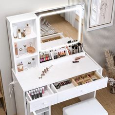 a white vanity with lots of cosmetics on it